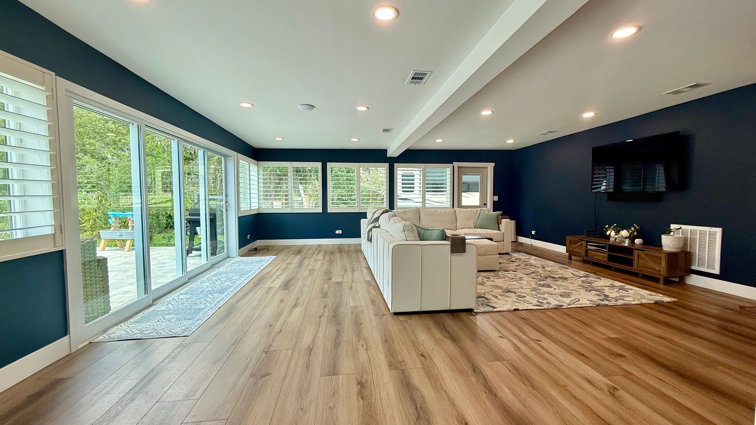 Completed interior renovation with flooring, recessed lighting, and trim